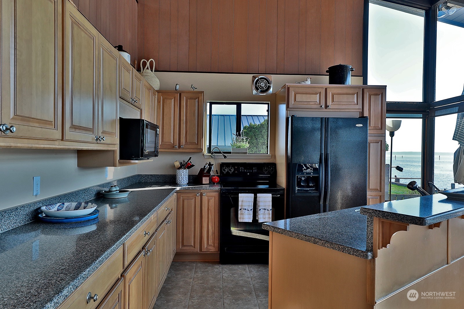 8166 Sandy Hook Drive Clinton, WA 98236 - Photo 16 of 40 a kitchen with stainless steel appliances granite countertop a refrigerator and a sink
