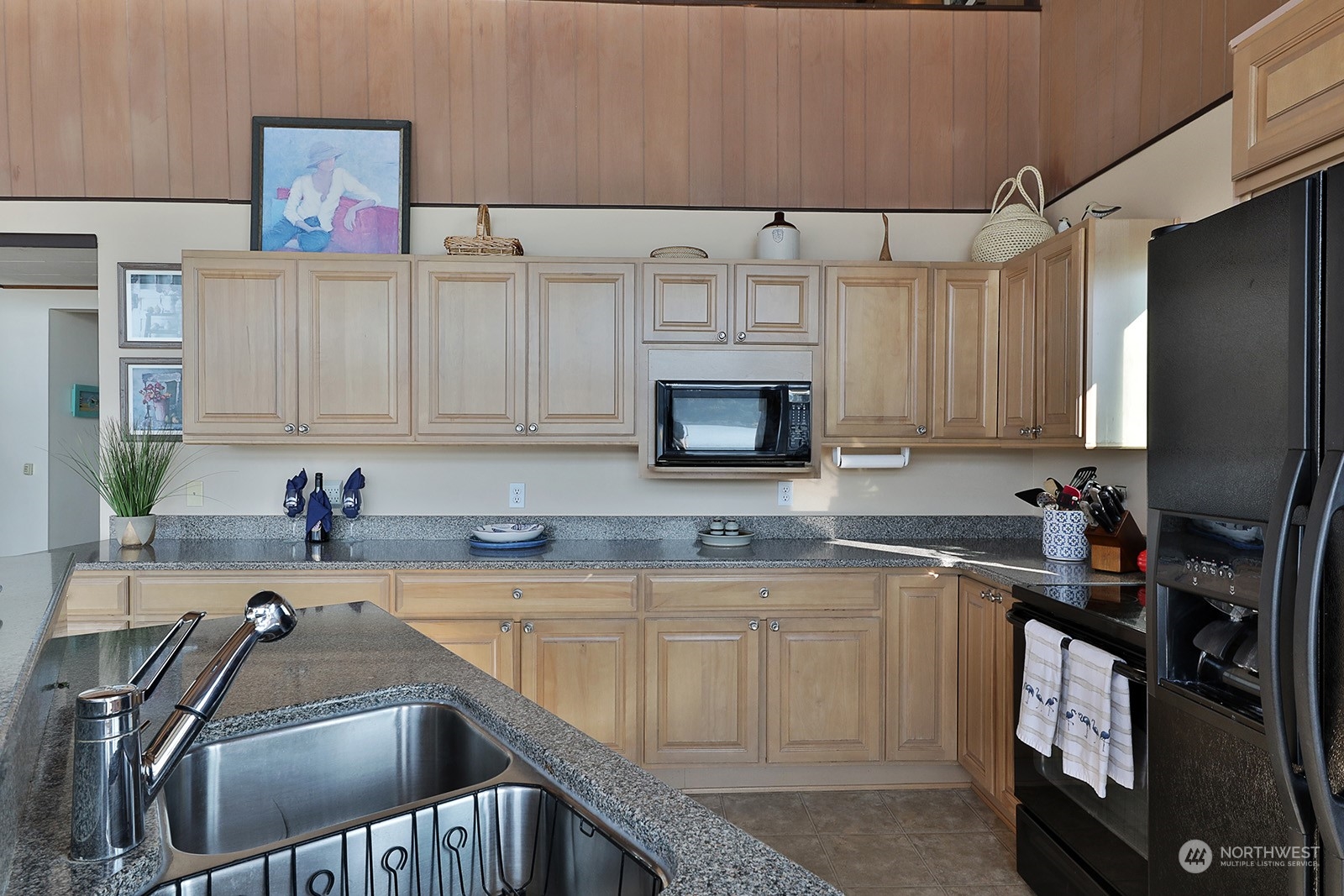 8166 Sandy Hook Drive Clinton, WA 98236 - Photo 17 of 40 a kitchen with stainless steel appliances a sink a stove and a refrigerator