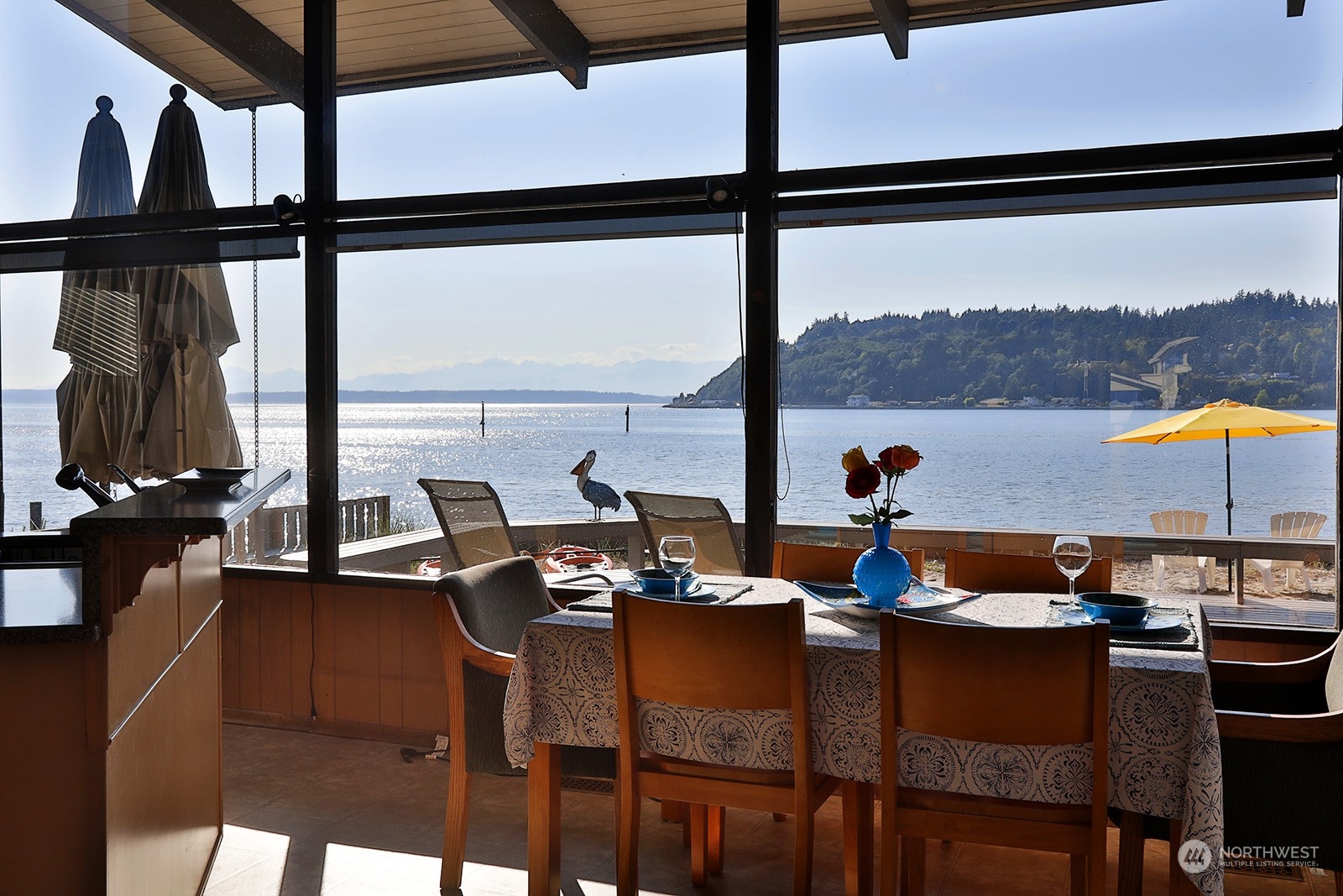 8166 Sandy Hook Drive Clinton, WA 98236 - Photo 18 of 40 a view of a dining room with furniture and window