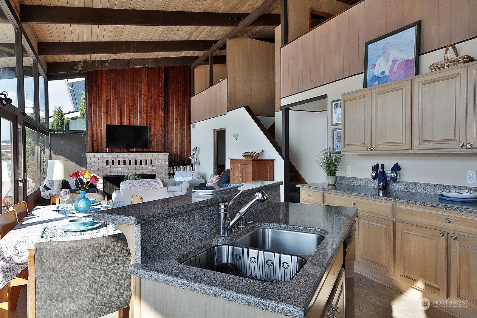 8166 Sandy Hook Drive Clinton, WA 98236 - Photo 19 of 40 a kitchen with stainless steel appliances kitchen island granite countertop a sink and white cabinets