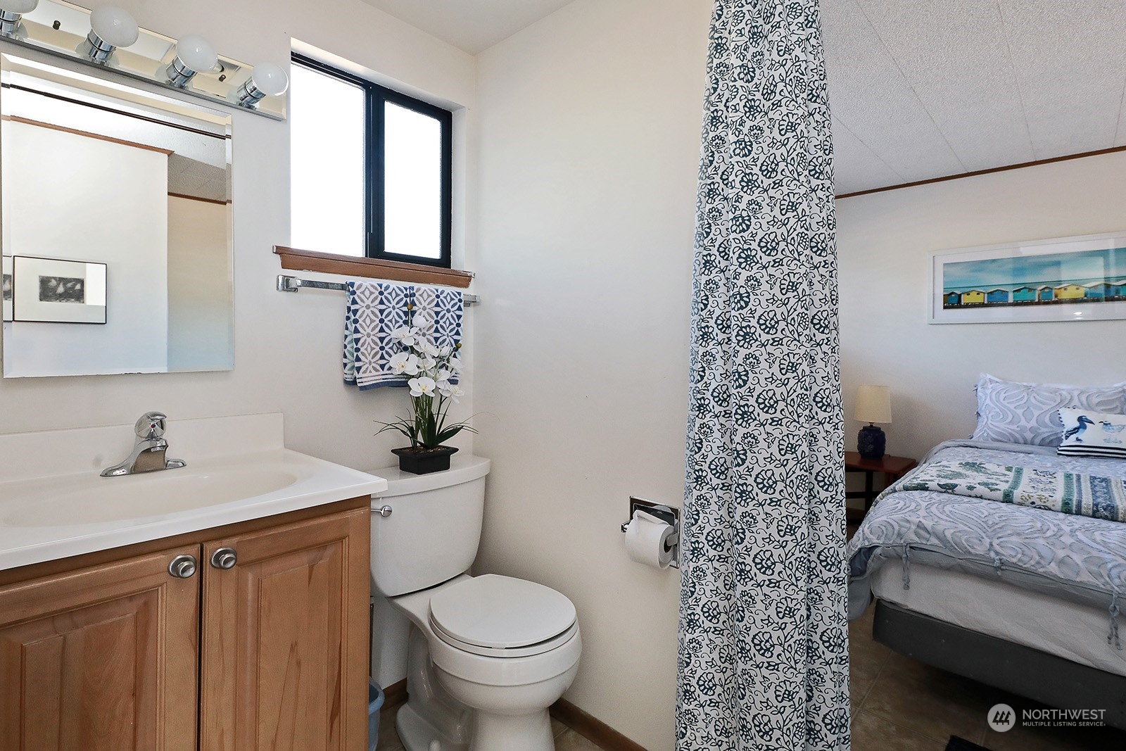8166 Sandy Hook Drive Clinton, WA 98236 - Photo 22 of 40 a bathroom with a sink toilet and shower