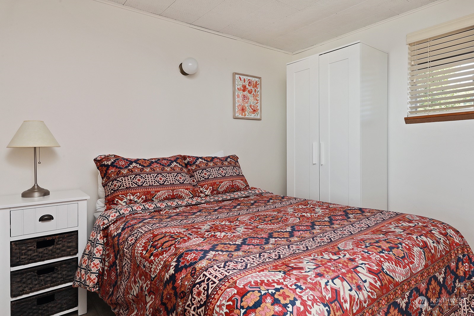 8166 Sandy Hook Drive Clinton, WA 98236 - Photo 24 of 40 a large bed sitting in a bedroom next to a window