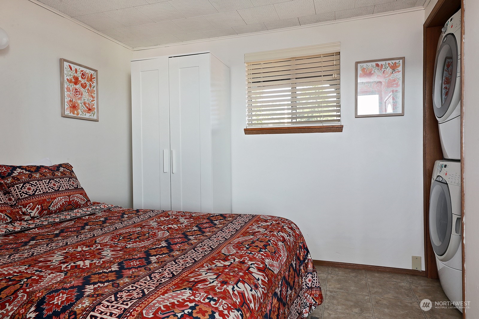 8166 Sandy Hook Drive Clinton, WA 98236 - Photo 25 of 40 a bedroom with a bed and a window