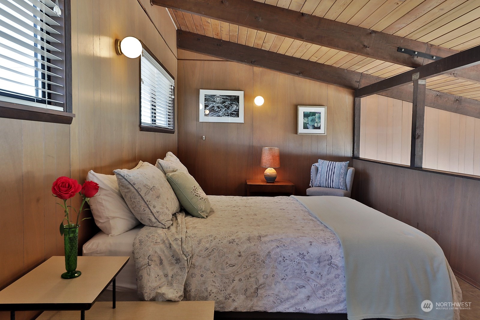 8166 Sandy Hook Drive Clinton, WA 98236 - Photo 27 of 40 a bedroom with a bed and a lamp with the wooden floor