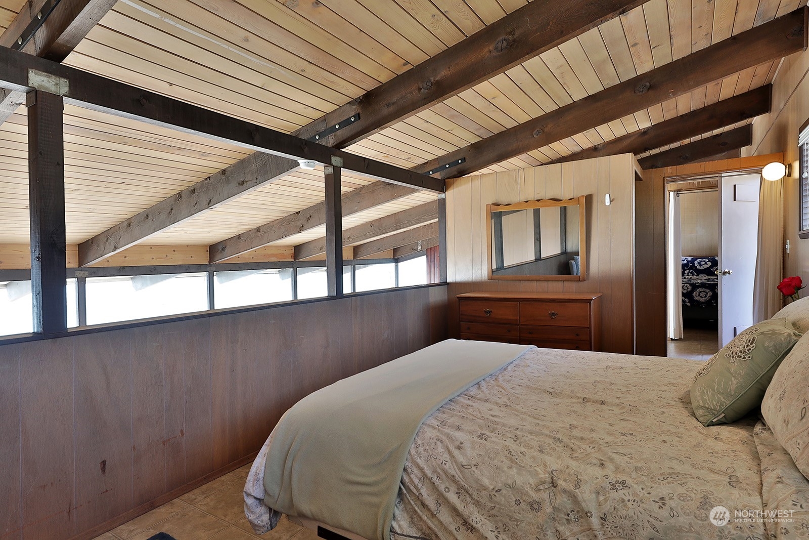 8166 Sandy Hook Drive Clinton, WA 98236 - Photo 28 of 40 a bedroom with a large bed and a window