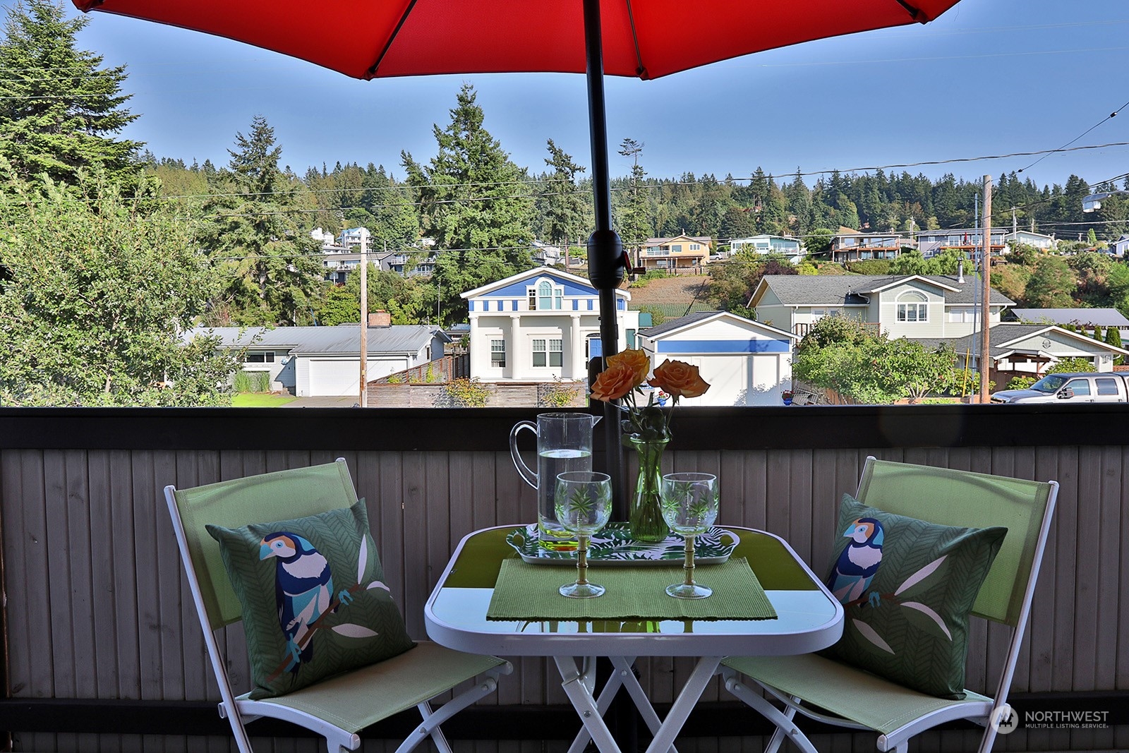 8166 Sandy Hook Drive Clinton, WA 98236 - Photo 30 of 40 a view of a balcony with chairs and a potted plant