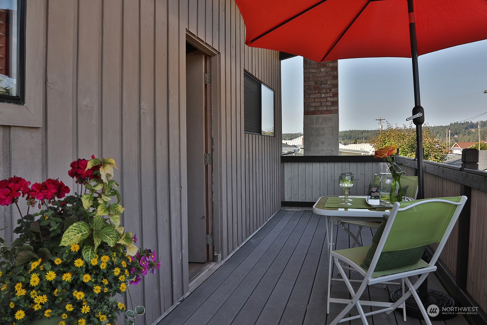 8166 Sandy Hook Drive Clinton, WA 98236 - Photo 31 of 40 a dining room with furniture and wooden floor