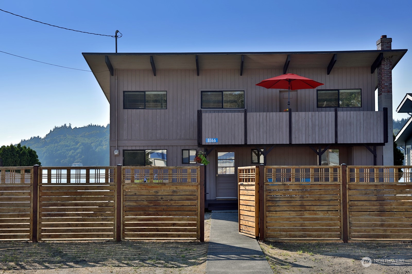 8166 Sandy Hook Drive Clinton, WA 98236 - Photo 8 of 40 a front view of a house with a garage