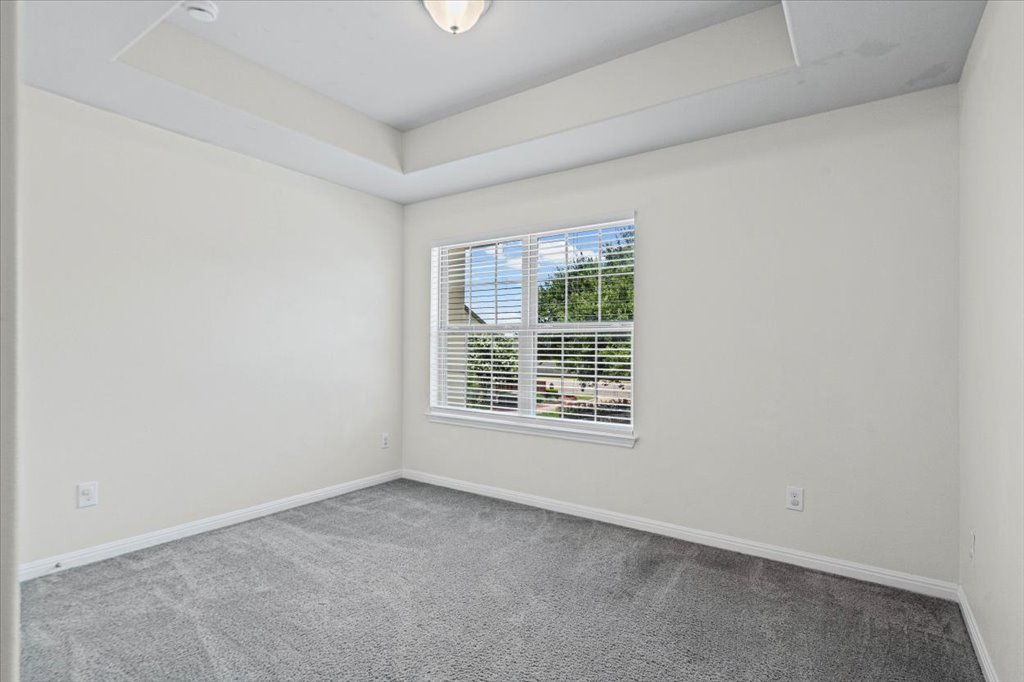 1502 Airedale Road, Unit 2502 Austin, TX 78748 - Photo 23 of 28 A well-lit room presents a neutral color palette, ready for personalization.