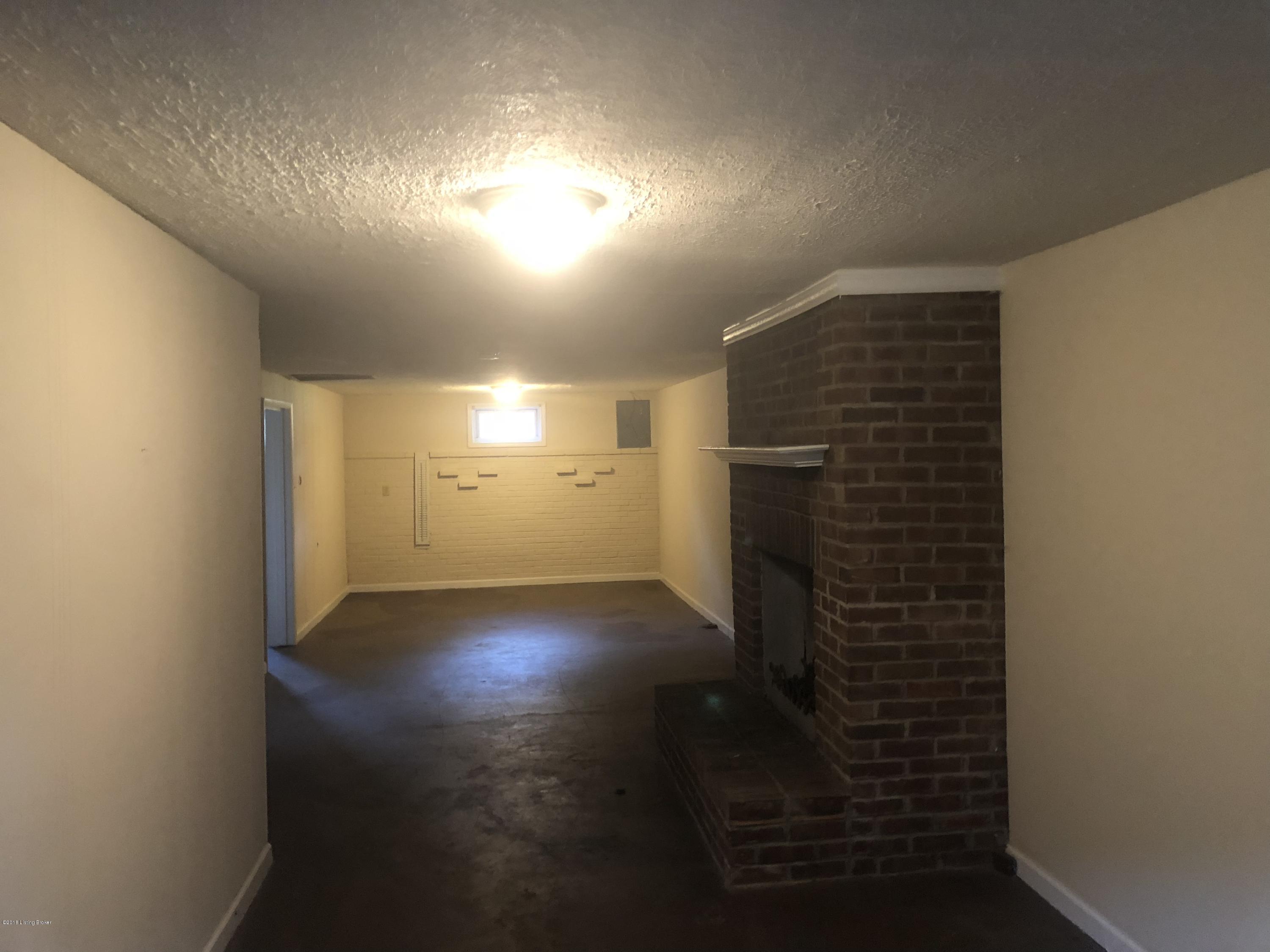 6916 Ledgerock Road Louisville, KY 40219 - Photo 15 of 18 Family room in basement with fireplace!