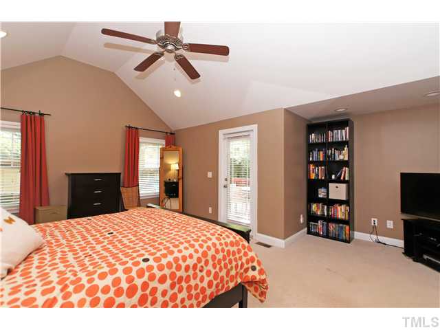 2827 Mayview Road Raleigh, NC 27607 - Photo 12 of 24 a bedroom with a bed and a flat screen tv
