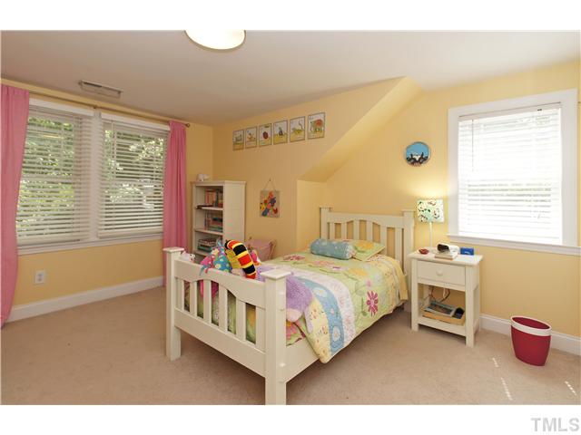 2827 Mayview Road Raleigh, NC 27607 - Photo 17 of 24 a bedroom with a bed and a window