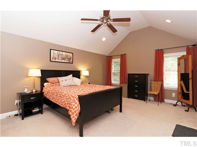 2827 Mayview Road Raleigh, NC 27607 - Photo 10 of 24 a bedroom with a bed dresser and a ceiling fan