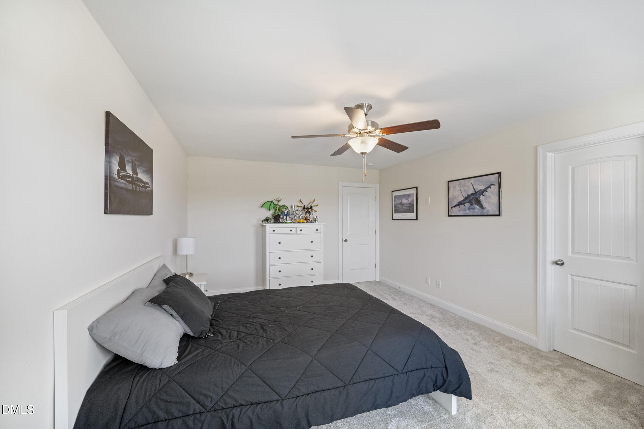 3541 Fairstone Road Wake Forest, NC 27587 - Photo 25 of 39 a bedroom with a bed and a chandelier