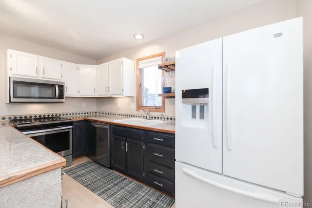 a kitchen with stainless steel appliances granite countertop a stove and a refrigerator
