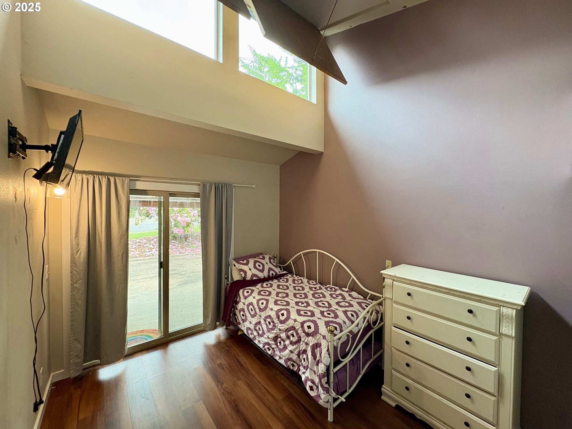 892 South 55th Place Springfield, OR 97478 - Photo 16 of 35 a bedroom with a bed and wooden floor