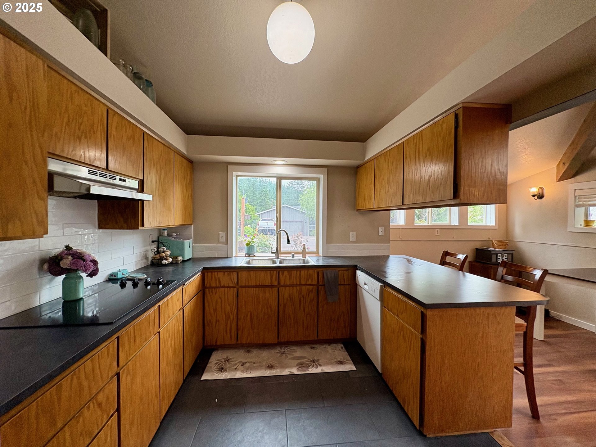 892 South 55th Place Springfield, OR 97478 - Photo 7 of 35 a kitchen with stainless steel appliances granite countertop a sink stove and cabinets