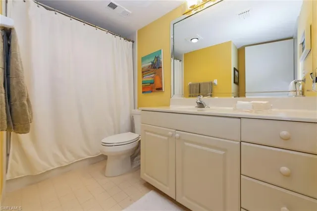 a bathroom with a toilet a sink and a mirror