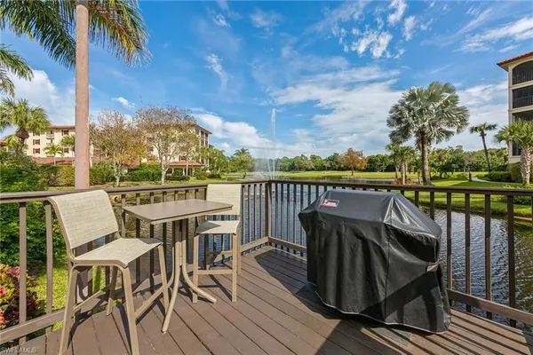 a view of a balcony with chairs and wooden floor