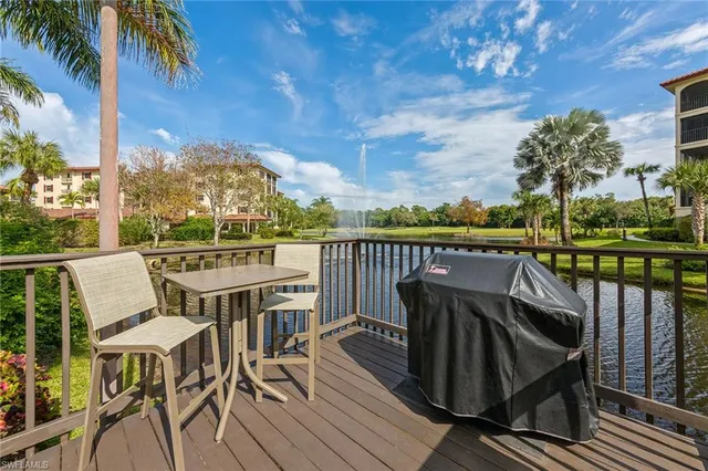 a view of a balcony with chairs and wooden floor