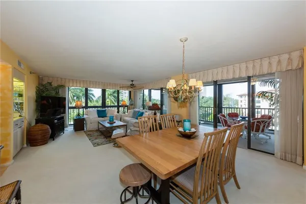 a view of a dining room with furniture window and outside view