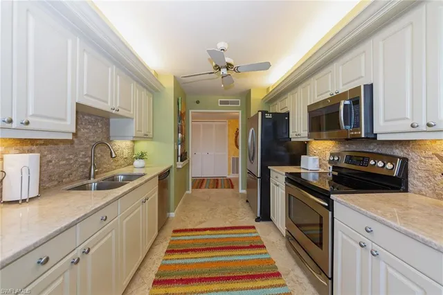 a kitchen with a sink stove and refrigerator