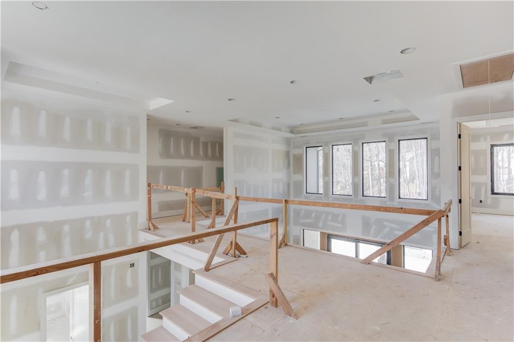 806 Riverside Road Sugar Hill, GA 30518 - Photo 18 of 40 a view of an empty room with wooden floor and windows