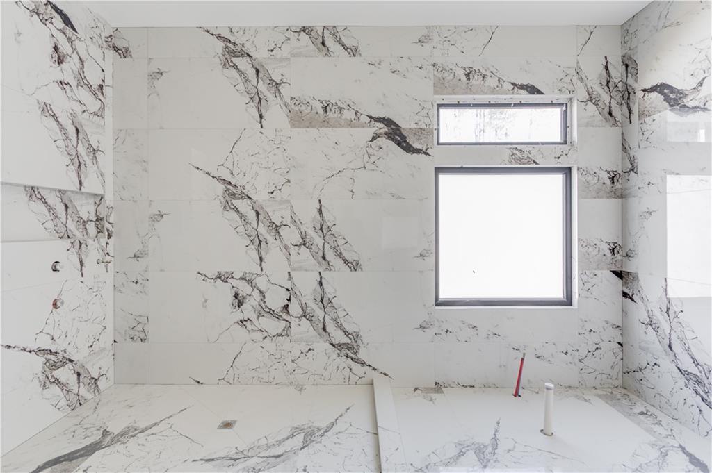 806 Riverside Road Sugar Hill, GA 30518 - Photo 23 of 40 a bathroom with a bathtub and shower