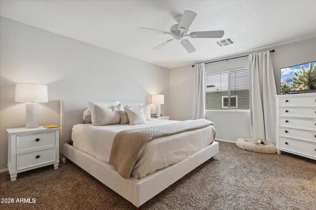 a bedroom with a bed and a dresser