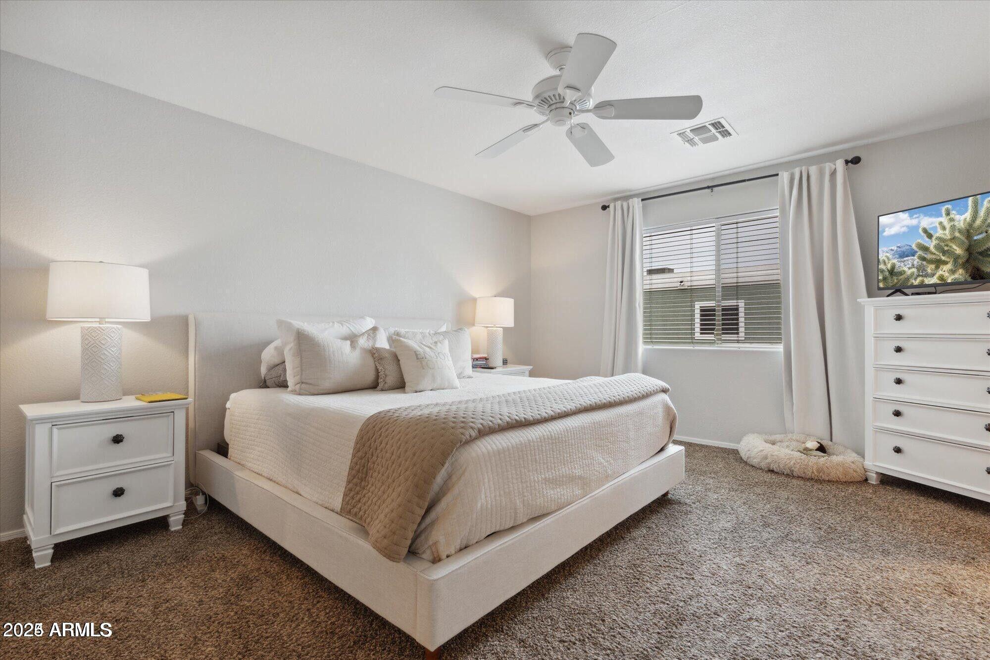 5210 North 16th Drive Phoenix, AZ 85015 - Photo 11 of 26 a bedroom with a bed and a dresser