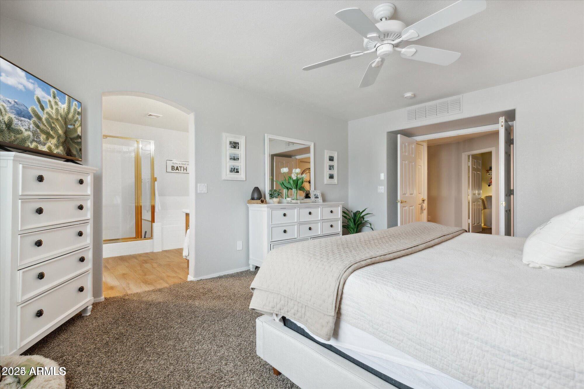 5210 North 16th Drive Phoenix, AZ 85015 - Photo 12 of 26 a spacious bedroom with a bed and a chandelier