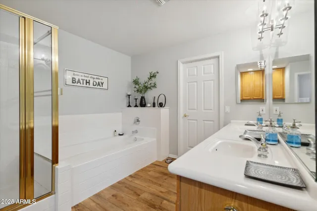a bathroom with a tub sink and mirror