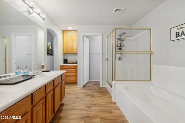 a bathroom with a sink a mirror and a bathtub