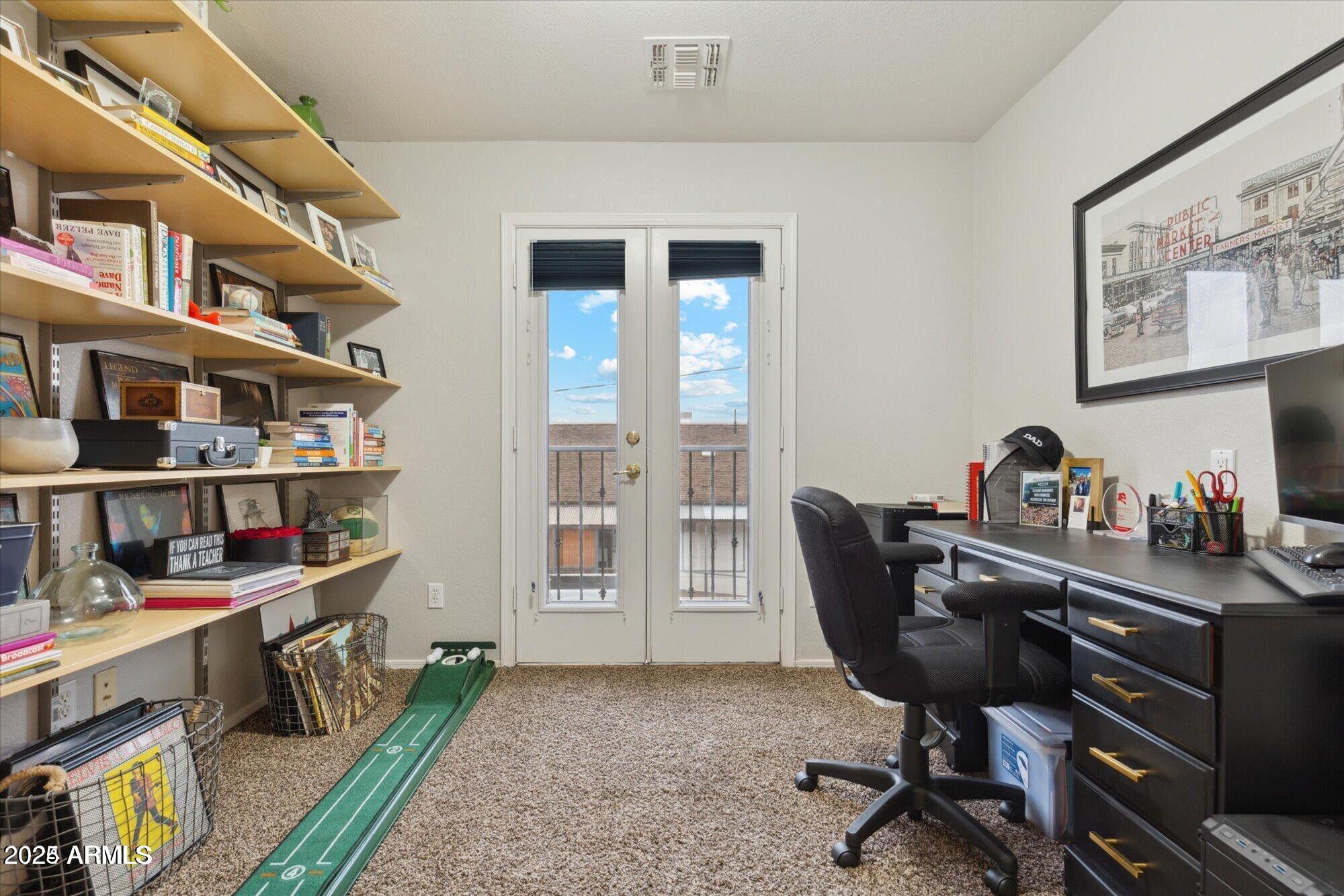 5210 North 16th Drive Phoenix, AZ 85015 - Photo 18 of 26 a view of a workspace with bookshelf and a window