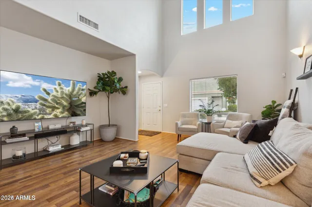 a living room with furniture and wooden floor