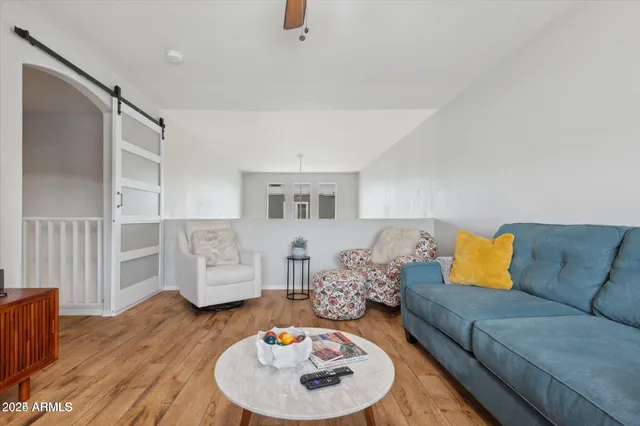 a living room with furniture and a wooden floor