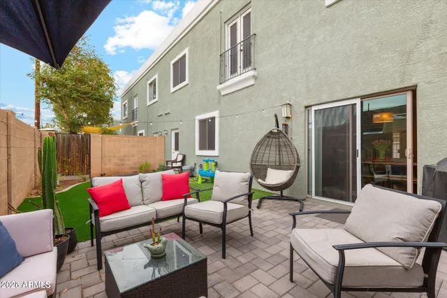 a outdoor living with furniture a rug and a potted plant