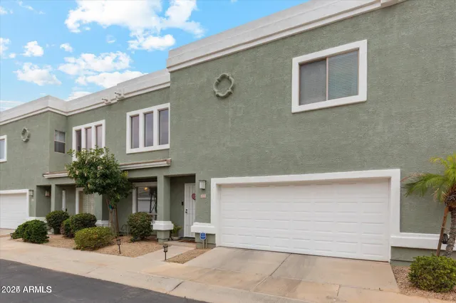 a front view of a house with yard and garage