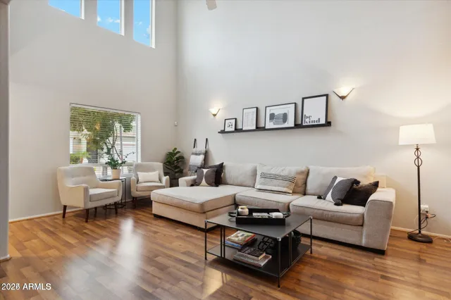 a living room with furniture and a wooden floor