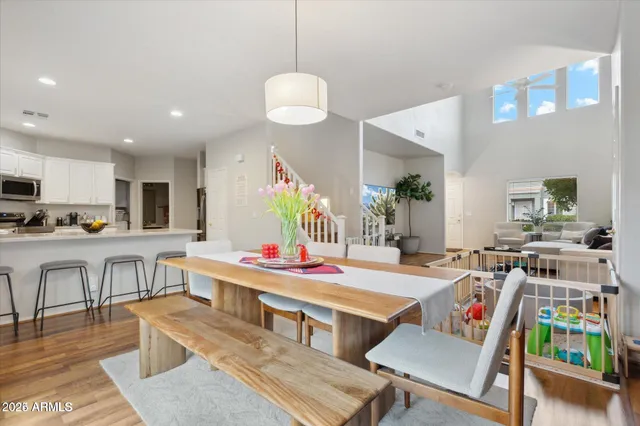 a room with lots of furniture and view of kitchen