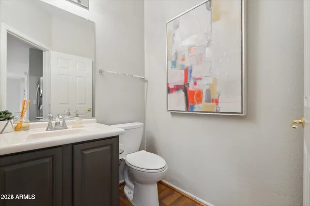 a bathroom with a toilet a sink and mirror