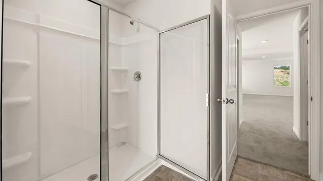a bathroom with a shower and a glass door