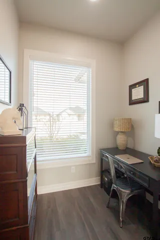 a dining room with furniture and a window