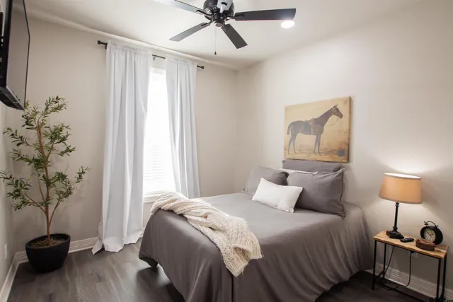a bedroom with a bed and a potted plant