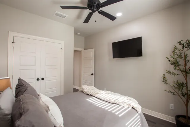 a bedroom with a bed and a flat screen tv