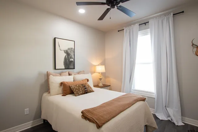 a bedroom with a bed and a window