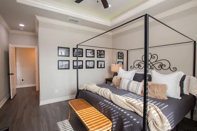 a bedroom with furniture and wooden floor
