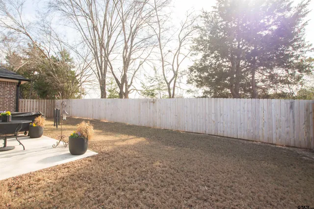 a view of outdoor space with wooden fence