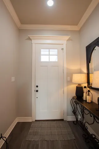 a view of an entryway with wooden floor
