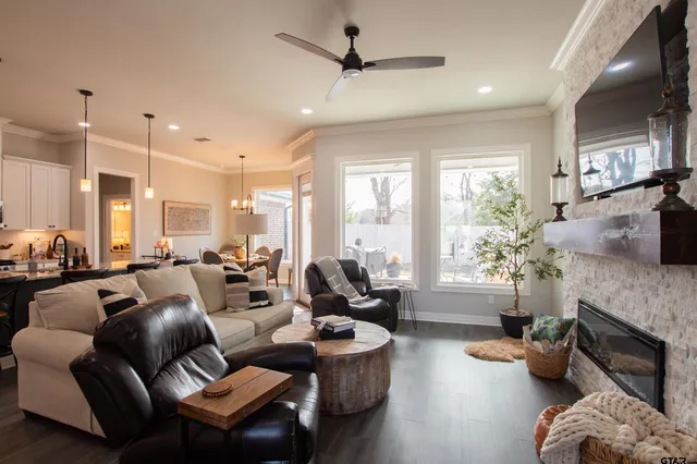 a living room with fireplace furniture and a large window